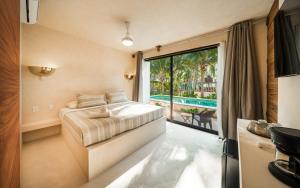 a bedroom with a bed and a large window at Cocuna Boutique Suites La Manzanilla Jalisco in La Manzanilla +76 photos