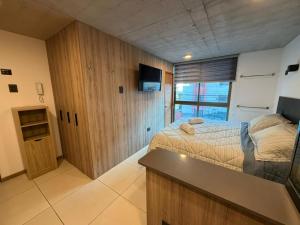 a bedroom with a bed and a desk in it at Hoteles JMC in Antofagasta