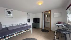 a bedroom with a bed and a bathroom with a sink at Agnieszkas Pension in Havelberg