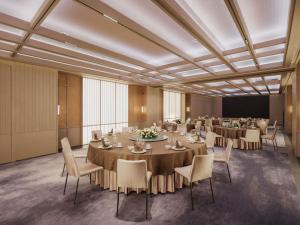 a conference room with tables and chairs and a screen at Ming Hotel Nanjing - MGallery Collection in Nanjing +148 photos