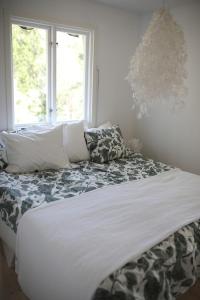 a bed in a room with a window at Das Elchhaus in Saltsjöbaden
