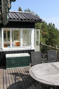 a patio with a table and chairs on a deck at Das Elchhaus in Saltsjöbaden