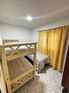 a bedroom with two bunk beds and a curtain at Depto hube in La Banda