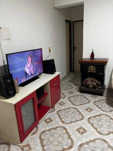 a living room with a flat screen tv and a fireplace at Depto hube in La Banda