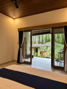 a bedroom with a large window with a view of a yard at Chez Lepusa in Sidemen