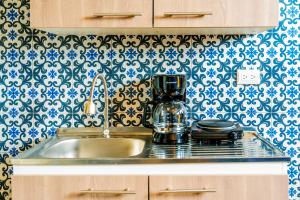a kitchen counter with a sink and a mixer at Villa Verona in Guatemala +28 photos