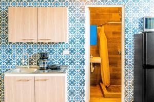a kitchen with a sink and a refrigerator at Villa Verona in Guatemala