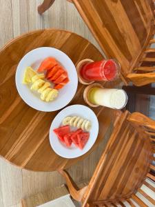 two white plates of food on a wooden table at Swariguna homestay in Sidemen +12 photos