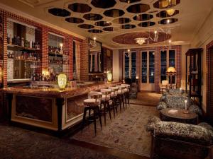 a bar in a room with a bunch of chairs at Aliée Istanbul - A Paris Society Collection Hotel in Istanbul +179 photos