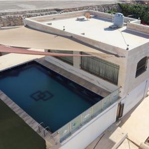 a swimming pool on the roof of a building at مزرعة نسيم جرش in Irbid