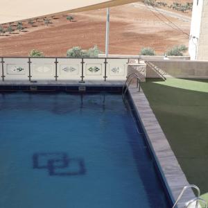 a large pool of water in front of a building at مزرعة نسيم جرش in Irbid