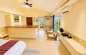 a hotel room with a bed and a kitchen at Rainbow Holiday Resort in Nadi