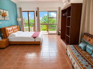a bedroom with a bed and a couch in it at Rainbow Holiday Resort in Nadi +62 photos