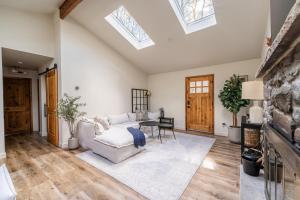 a living room with a white couch and a table at Modern Designed Cabin with Secluded Backyard Firepit Grill Nintendo Switch2 in Gouldsboro +42 photos
