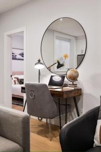 a room with a desk with a mirror on the wall at The North Shore Luxe Suite in North Vancouver