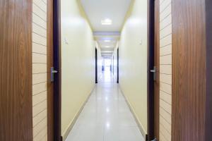 a corridor of a hospital hallway with doors at OYO Hotel O Allipuram Near Railway Station in Visakhapatnam