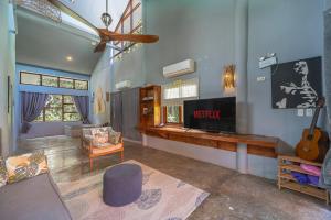 a living room with a couch and a tv at Union House with generator in Dapa