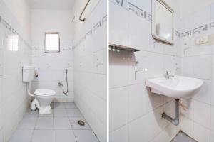 a white bathroom with a sink and a toilet at OYO Hotel O Allipuram Near Railway Station in Visakhapatnam