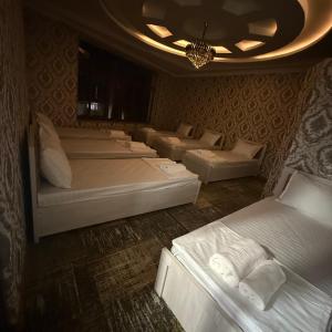 a room with a bunch of beds in it at Geniuses in Samarkand