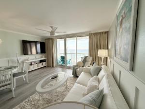 a living room with a couch and a table at Beachfront Condos in Destin in Destin