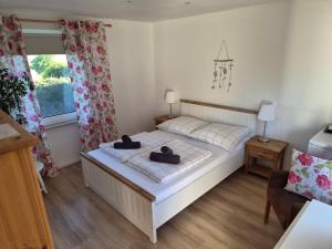 a bedroom with a bed with two hats on it at Pension am Silberberg in Gartz an der Oder