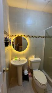a bathroom with a toilet and a sink at Villa azuero in Los Santos +17 photos
