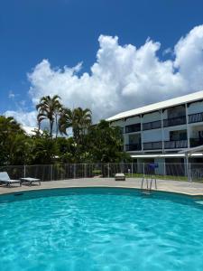 a large swimming pool in front of a building at Studio Atoumo Marine 5 in Saint-François