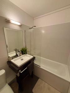 a bathroom with a sink and a shower and a toilet at Studio Atoumo Marine 5 in Saint-François +2 photos