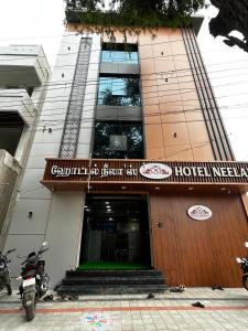 a hotel with a sign on the front of it at S Hotel Neela in Musiri