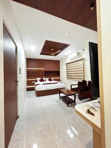a hotel room with a bed and a living room at S Hotel Neela in Musiri