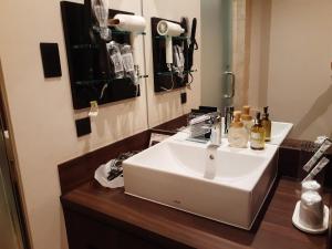a bathroom with a white sink and a mirror at Hotel Moana Otsuka (Adult Only) in Tokyo +25 photos
