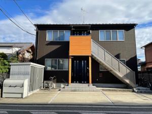 a house with a staircase in front of it at Yasuragi-KAWAGOE 2F in Kawagoe