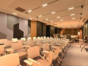 a conference room with white chairs and a podium at Mercure Tashkent North in Tashkent +127 photos