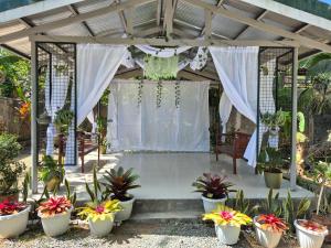 a pergola with potted plants in a garden at Sotera and Paz Forestville in Silang