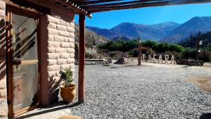 a stone building with a view of the mountains at Al Pie del Pucara in Tilcara