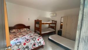 a small bedroom with a bed and a bunk bed and a bunk bed at Dream Country Cabin in Cañaveral