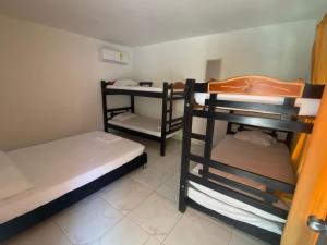 a room with three bunk beds in it at Dream Country Cabin in Cañaveral +2 photos