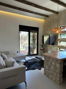 a living room with a couch and a table at Eden's Garden Villa in Ulcinj
