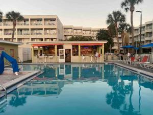 a swimming pool in front of a hotel at Bayfront 2BR2BA Condo at Sailport Minutes from Beaches & Downtown Attractions in Tampa
