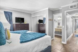 a bedroom with a bed with a blue blanket on it at Bayfront 2BR2BA Condo at Sailport Minutes from Beaches & Downtown Attractions in Tampa +23 photos