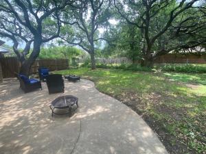 a patio with a table and chairs in a yard at Delaware Springs Home in Burnet