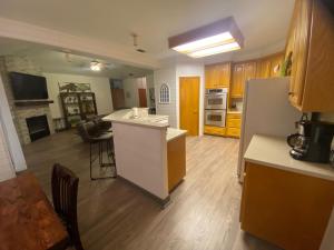 a kitchen with an island in the middle of a room at Delaware Springs Home in Burnet