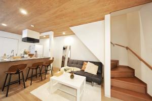 a living room and kitchen with a couch and a table at 愉楽の宿 一棟貸切Villa in Osaka +43 photos