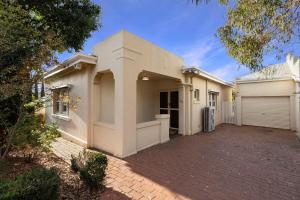 a large white house with a garage at Barkly Cottage Bendigo in Bendigo