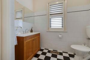 a bathroom with a sink and a toilet at Barkly Cottage Bendigo in Bendigo