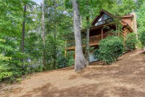 a log cabin in the woods with a tree at Afternoon Delight 1 Bedroom Cabin Rental between Gatlinburg and Pigeon Forge Great Couple getaway in Sevierville