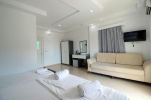 a living room with two beds and a couch at Hotel Beach Restaurant Fabio in Borsh