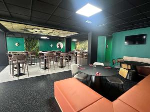 a restaurant with green walls and a table and chairs at Ibis Styles Lyon Gorge de Loup Saphir in Lyon