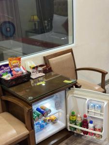 a small refrigerator with its door open in a room at Hoàng Gia Long Biên Hotel in Hanoi