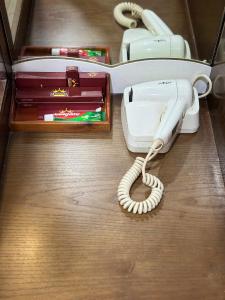 a white phone sitting on top of a table at Hoàng Gia Long Biên Hotel in Hanoi